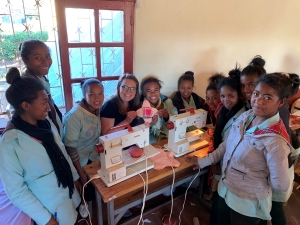 Girls in the community learn to sew reusable pads.
