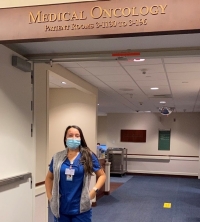 Idalis Figueroa '20 BSN stands in the hallways of her medical oncology unit