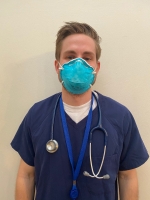 Male nurse dressed in scrubs.