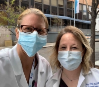 Female Nurses with masks stand outside of a Brooklyn hospital.