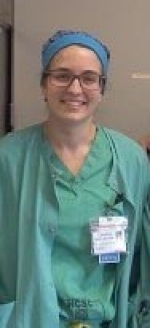 Female nurse dressed in green scrubs.