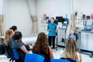 A professor giving a lecture to nursing students