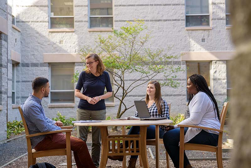 Students and faculty meeting outside