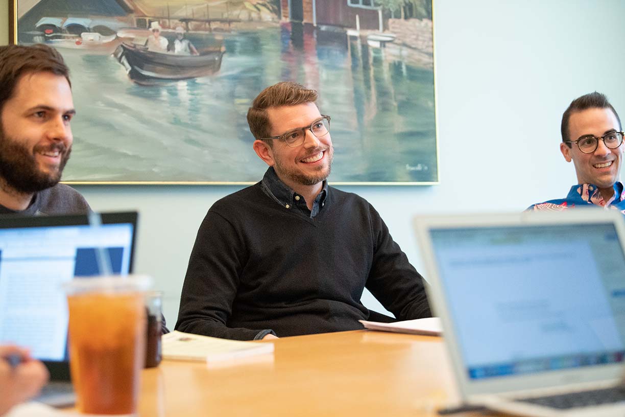 Students work together around a table.