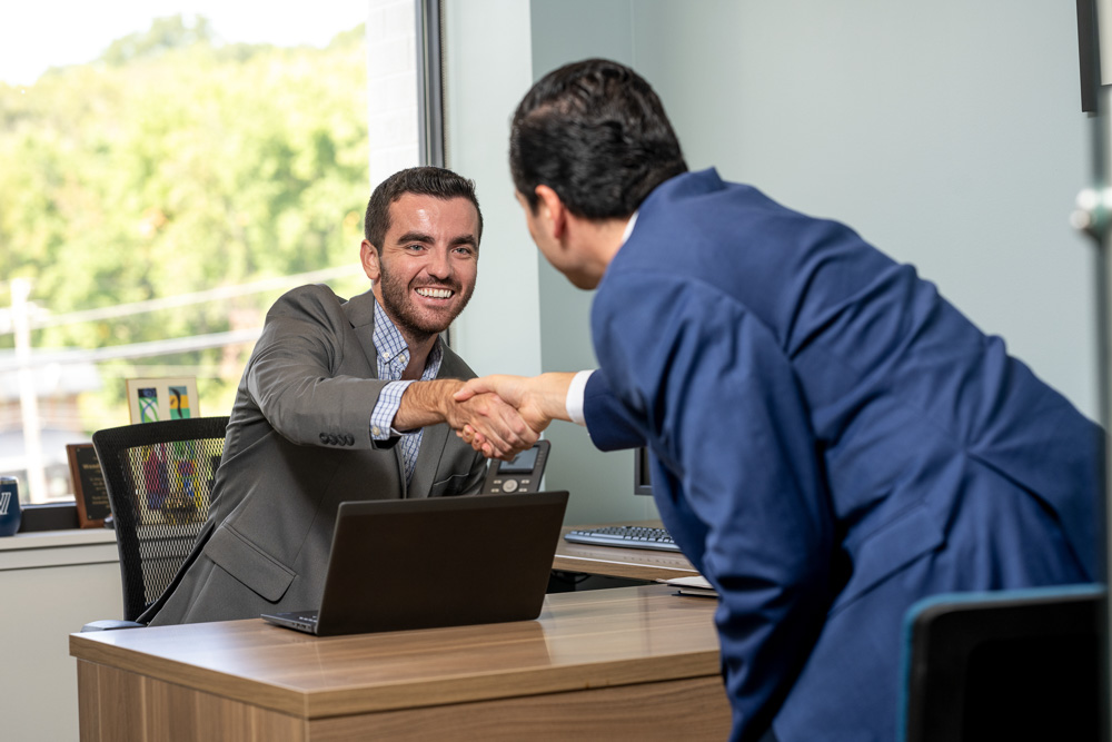 Two students shaking hands