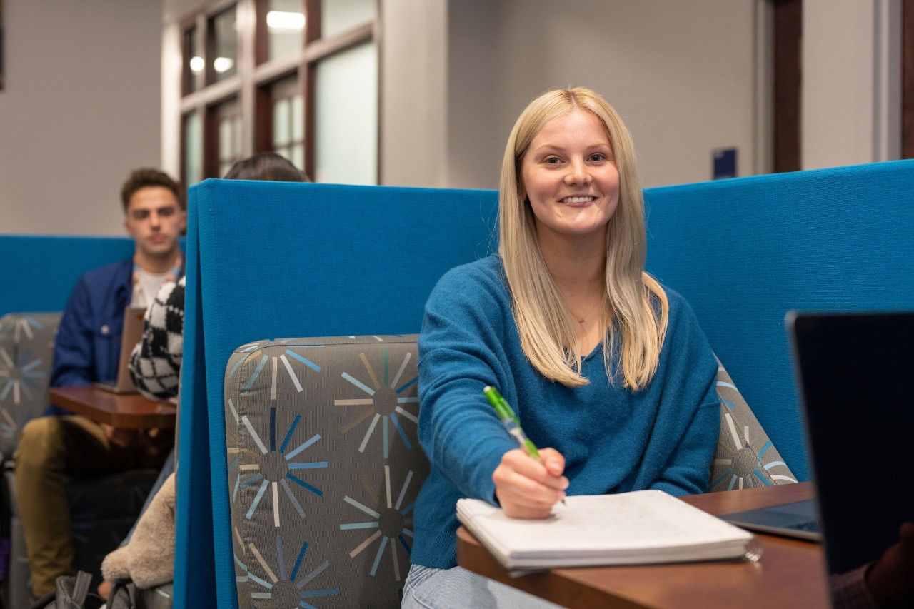 Female student studying in cubicle
