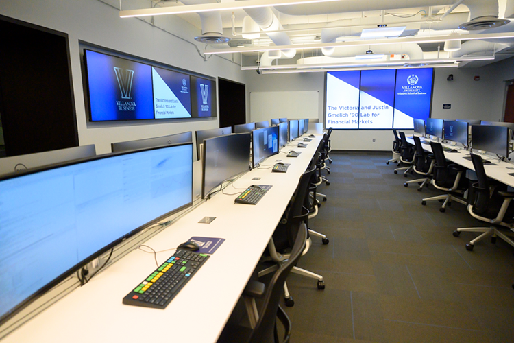Large computer screen on top of desk.