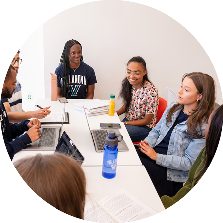 Students sitting and laughing at a table