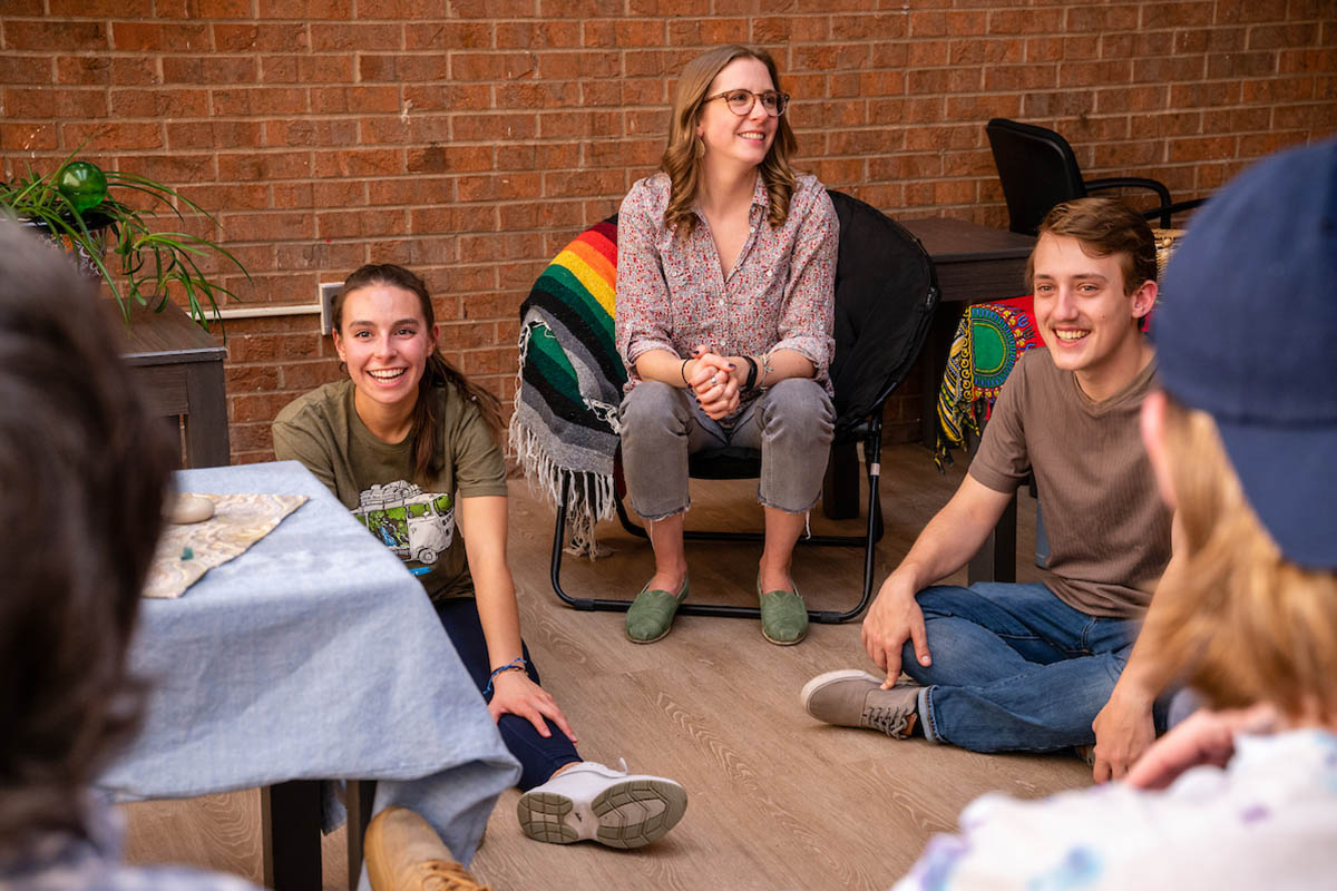 Students sitting and laughing on the floor