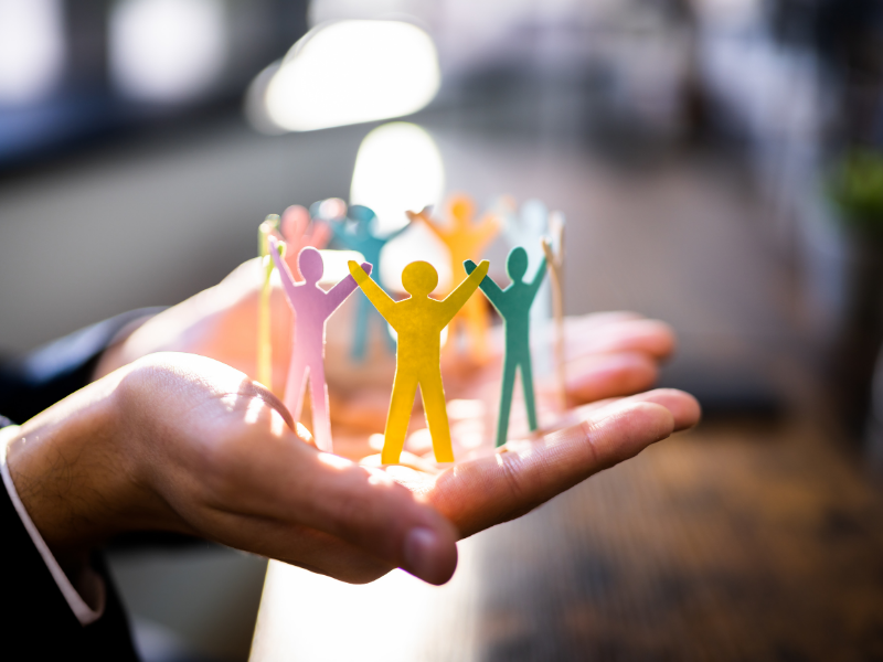 open hands with paper cutouts inside