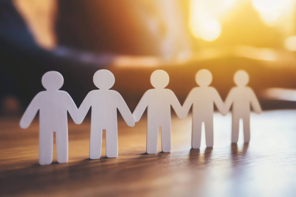 paper cutouts of people with backlit sunshine