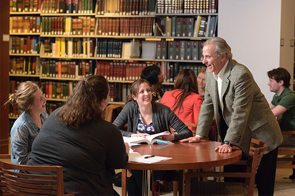 Jonathan Schiffman, JD, a professor in Villanova's Paralegal program, interacts with students in the library.