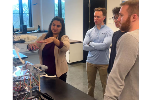 Professor demonstrating lab experiment for students