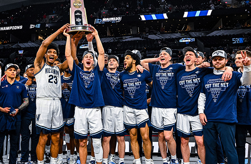 The Villanova Men's Basketball Team celebrate winning the BIG EAST championship as two players hold their trophy overhead