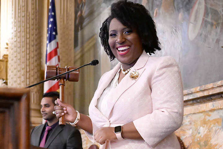 Joanna McClinton smiling and holding a gavel