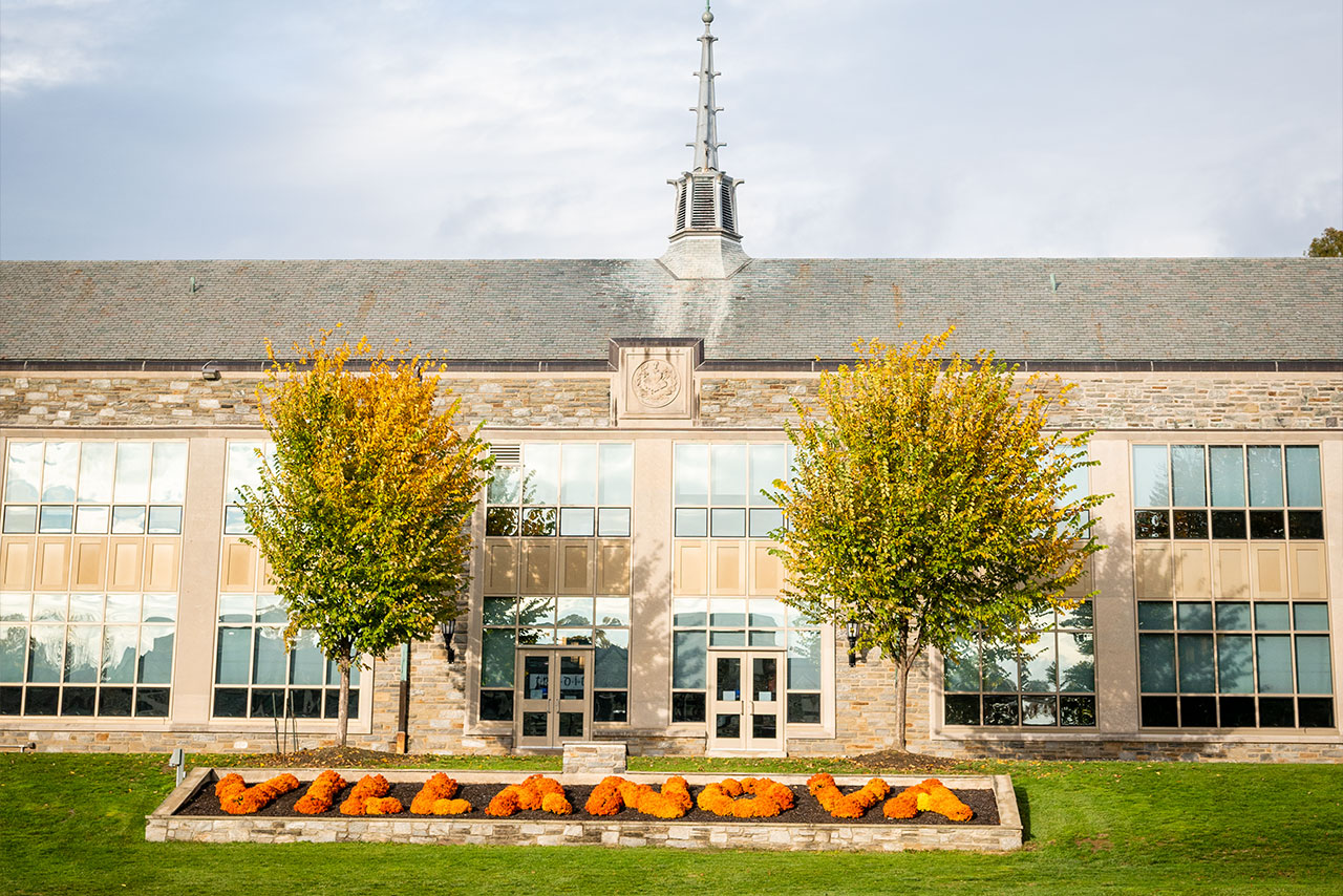 Villanova is spelled out using orange mums outside Dougherty Hall