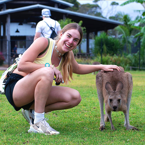 a female student poses with a kangaroo