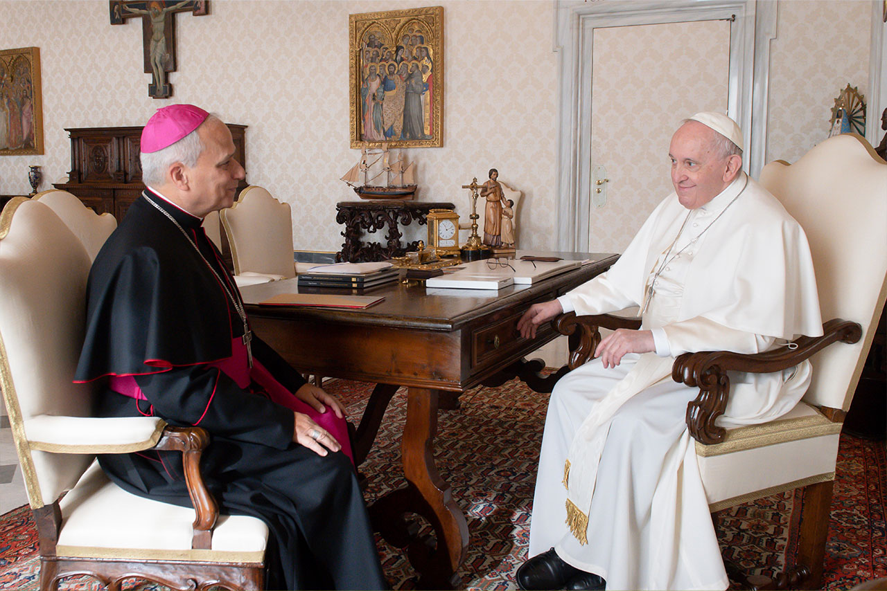 Cardinal Robert Francis Prevost sits across from Pope Francis at a desk in the Vatican