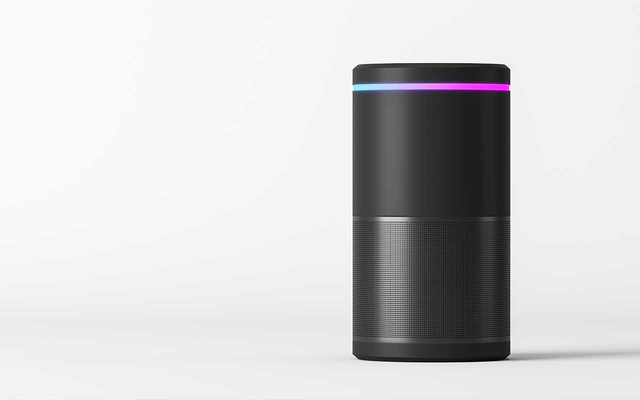 a black Amazon Echo with a light going from blue to purple