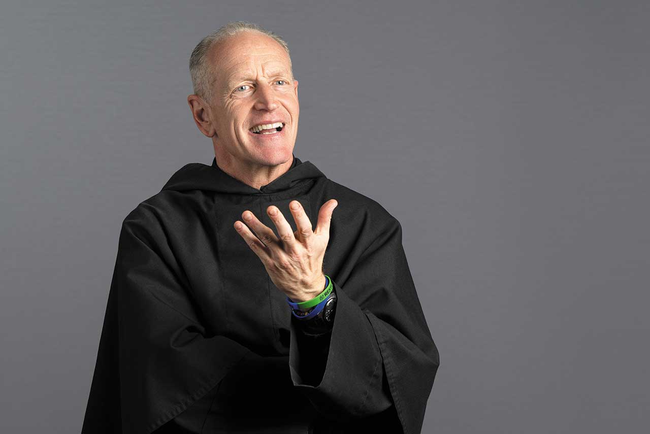 The Rev. Rob Hagan in a standing pose wearing a black Augustinian habit