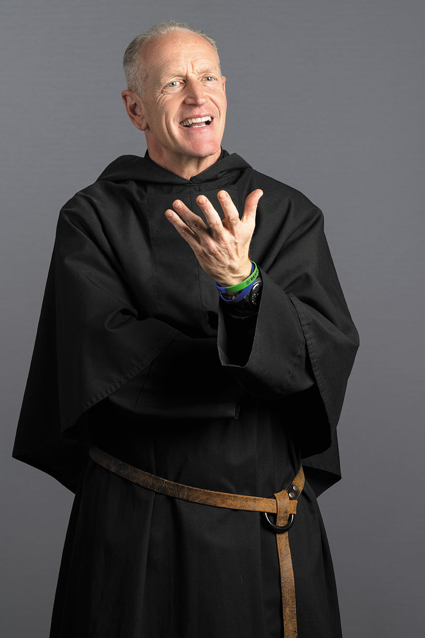 The Rev. Rob Hagan in a standing pose wearing a black Augustinian habit