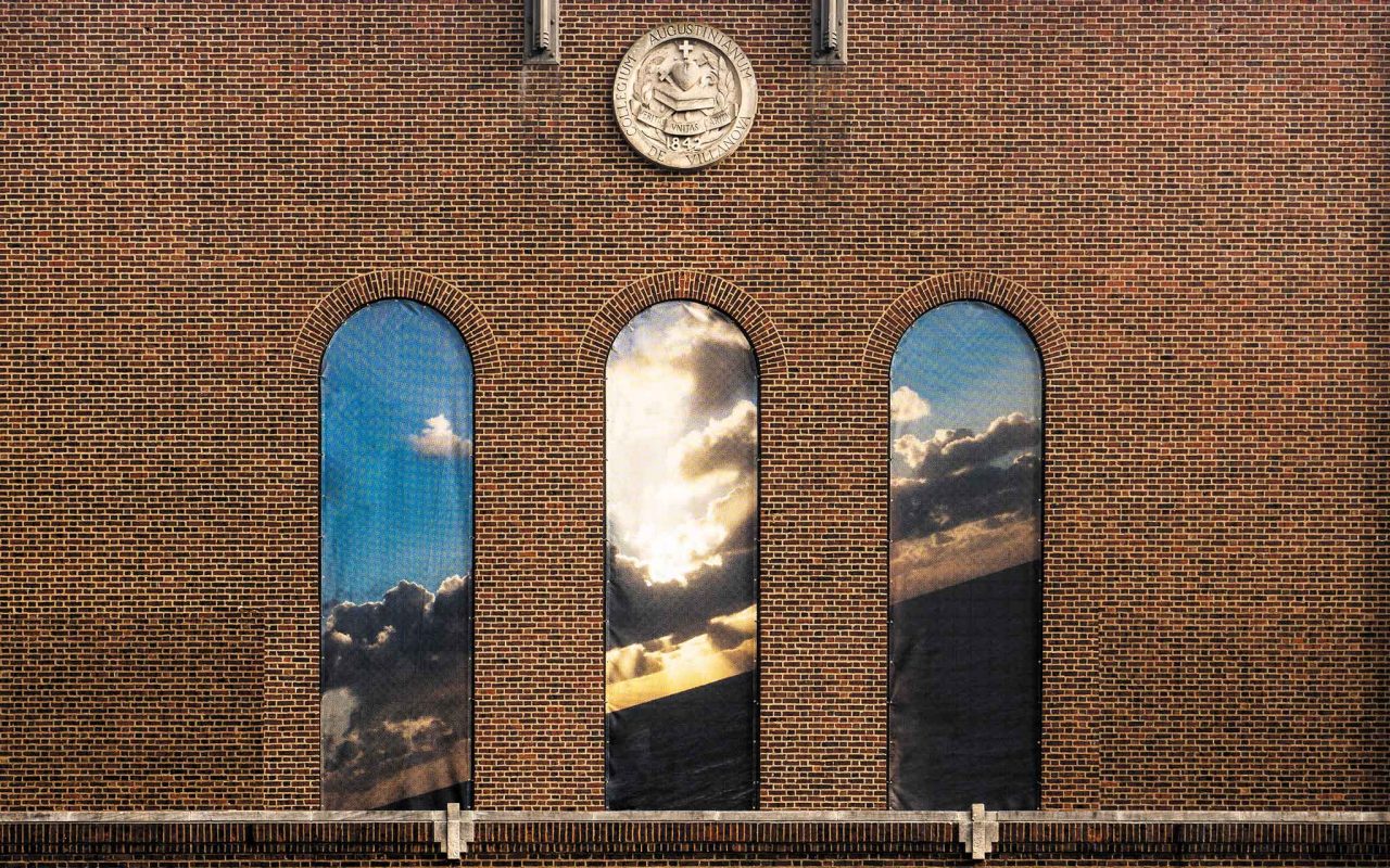 a massive photographic mural in the arched windows on Jake Nevin Field House