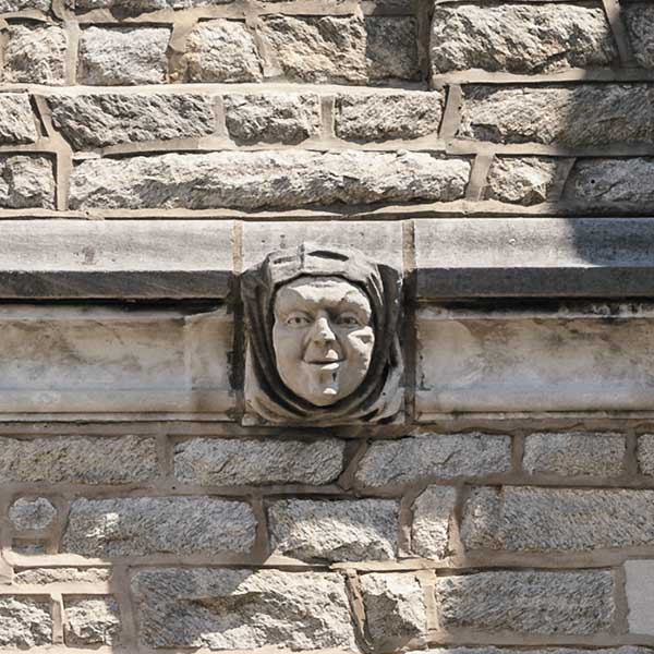 a face carved into a stone wall
