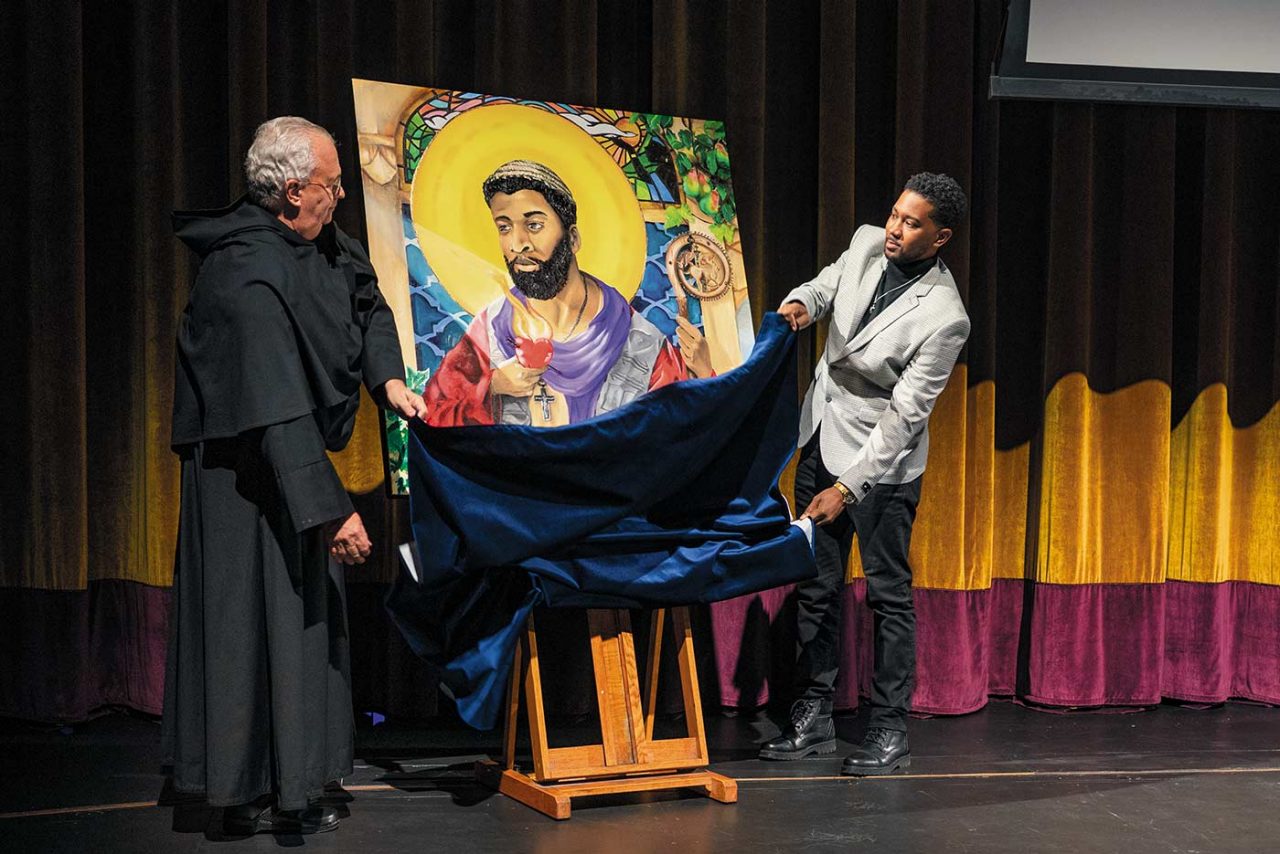 University President the Rev. Peter M. Donohue and artist Vernon Adams unveil a portrait of St. Augustine