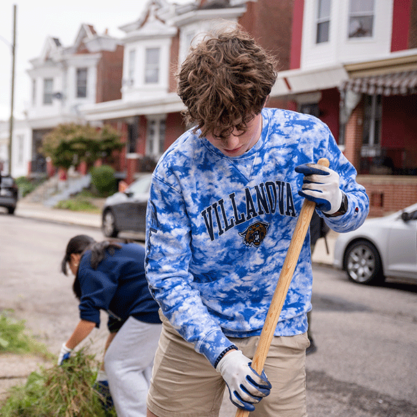 Villanova volunteers do yard work outside of row homes