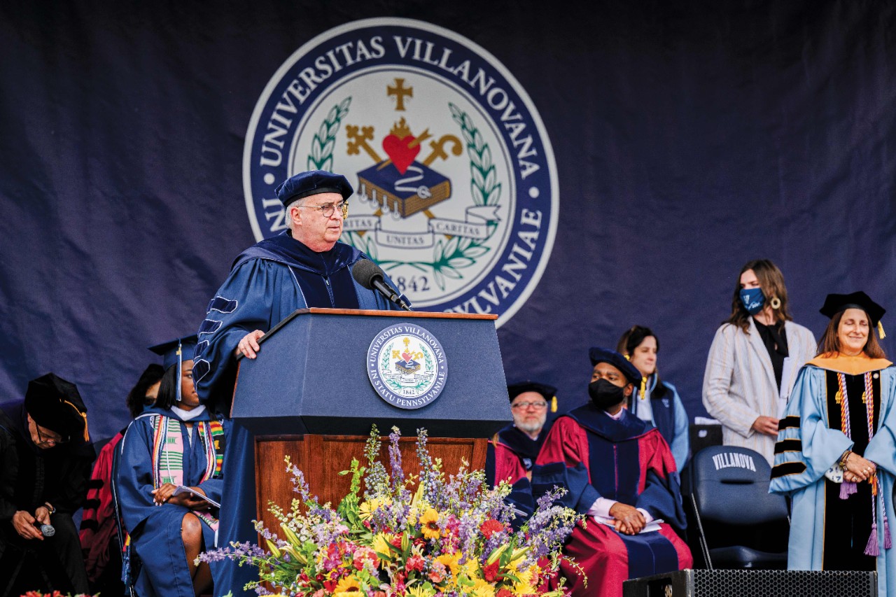 Villanova President Father Peter Donohue speaking from a podium at commencement