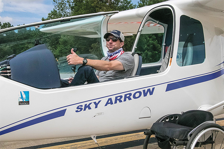 pilot Sean O'Donnell gives a thumbs up from the cockpit of a small aircraft