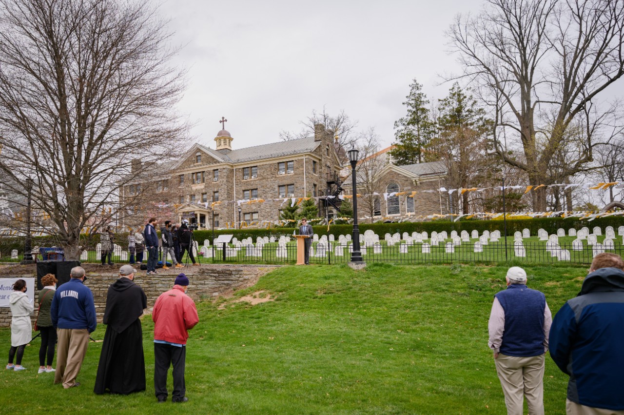 people gather at the Augustinian cemetery for the opening ceremony of the COVID Memorial