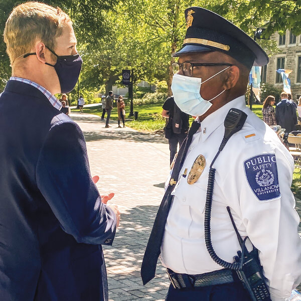 a Villanova Public Safety officer stands in conversation with a man