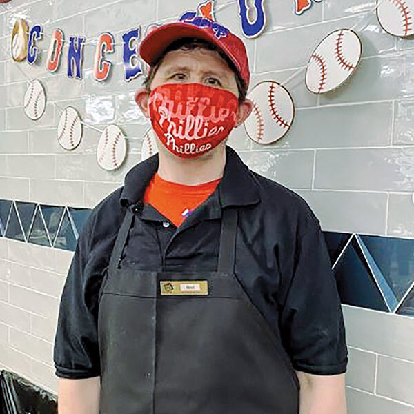 Villanova Dining Services staff person wearing a baseball cap and Phillies face mask