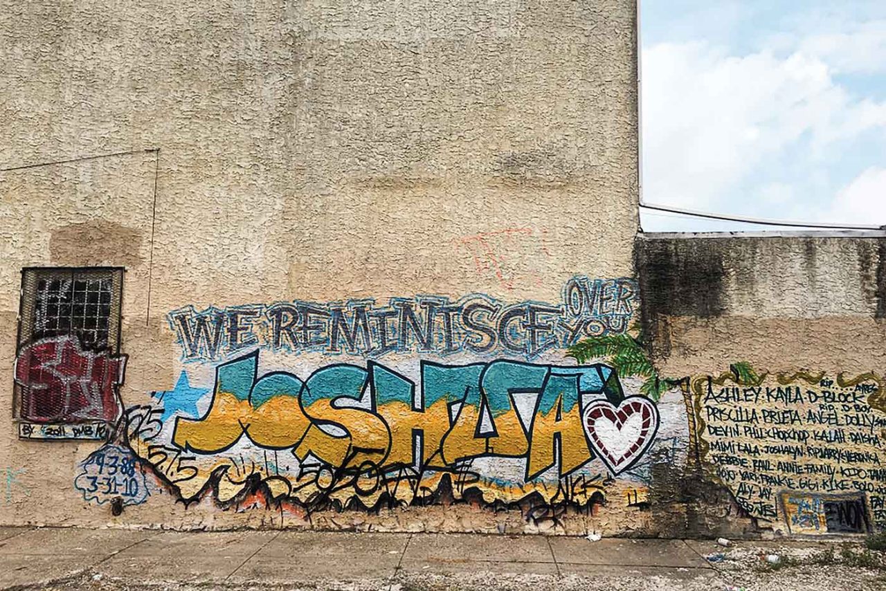 a graffiti memorial on a wall in Kensington