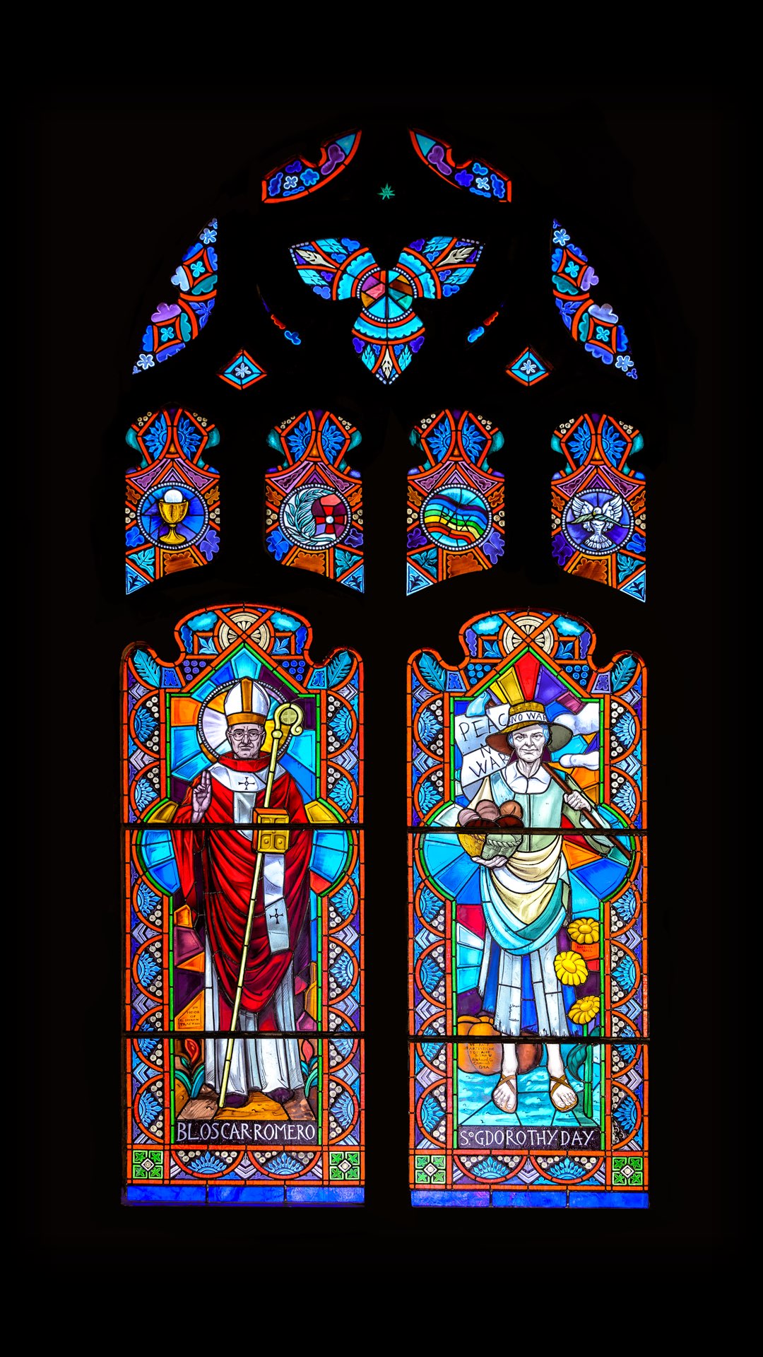 Stained glass windows depicting Blessed Oscar Romero and Servant of God Dorothy Day.