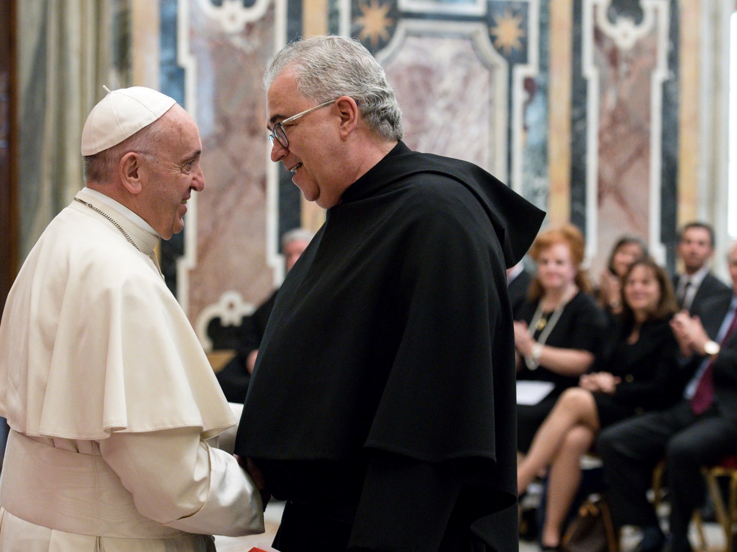 Pope Francis shakes hands with Villanova University President the Reverend Peter M. Donohue.
