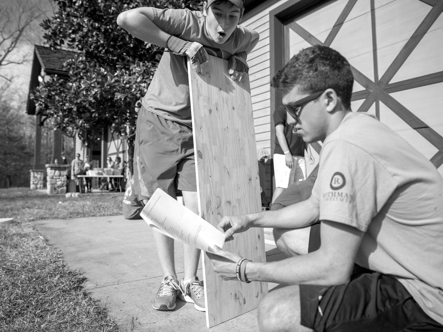 Black-and-white photo of Villanova students working on service project.