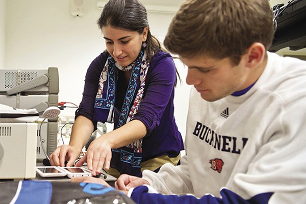 Amal Kabalan, assistant professor at Bucknell University, works with a student in the lab.