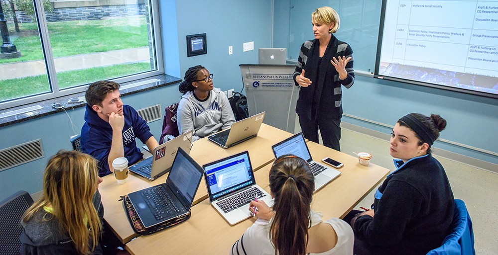 A Public Administration professor teaching in a small seminar group A Public Administration professor teaching in a small seminar group