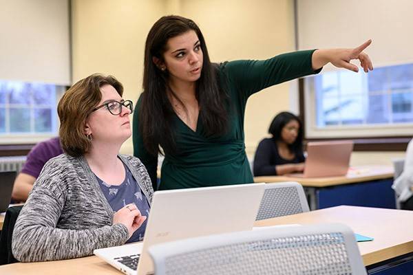 Teena M. Amador, Esq, works one-on-one with a student in Villanova's Paralegal program.