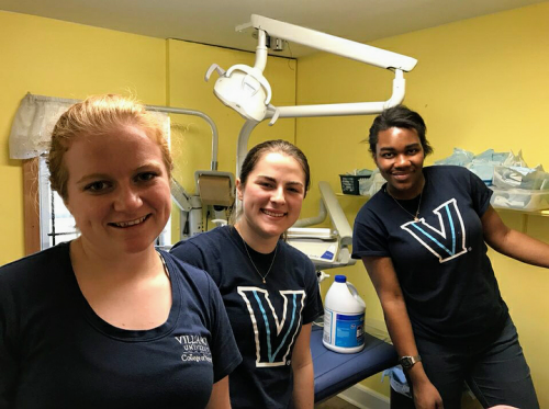 Three Villanova Nursing students at a foot care clinic for homeless clients which they run as part of their work with Nursing without Borders. 
